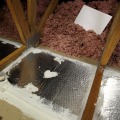 An airtight seal was creating on the framing of a rigid backer material with mastic.