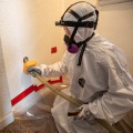 Weatherization technician injecting dense-pack cellulose insulation into interior walls of a homeInterior Sidewall Insulation