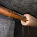 A pipe wrap insulation is installed along the water pipes of a home in order to reduce thermal loss