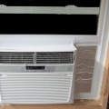A window air conditioner unit installed in a window opening.