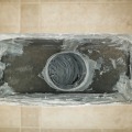 Gray mastic sealant from inside a supply duct boot.