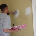 An installer seals insulation access holes from the interior.